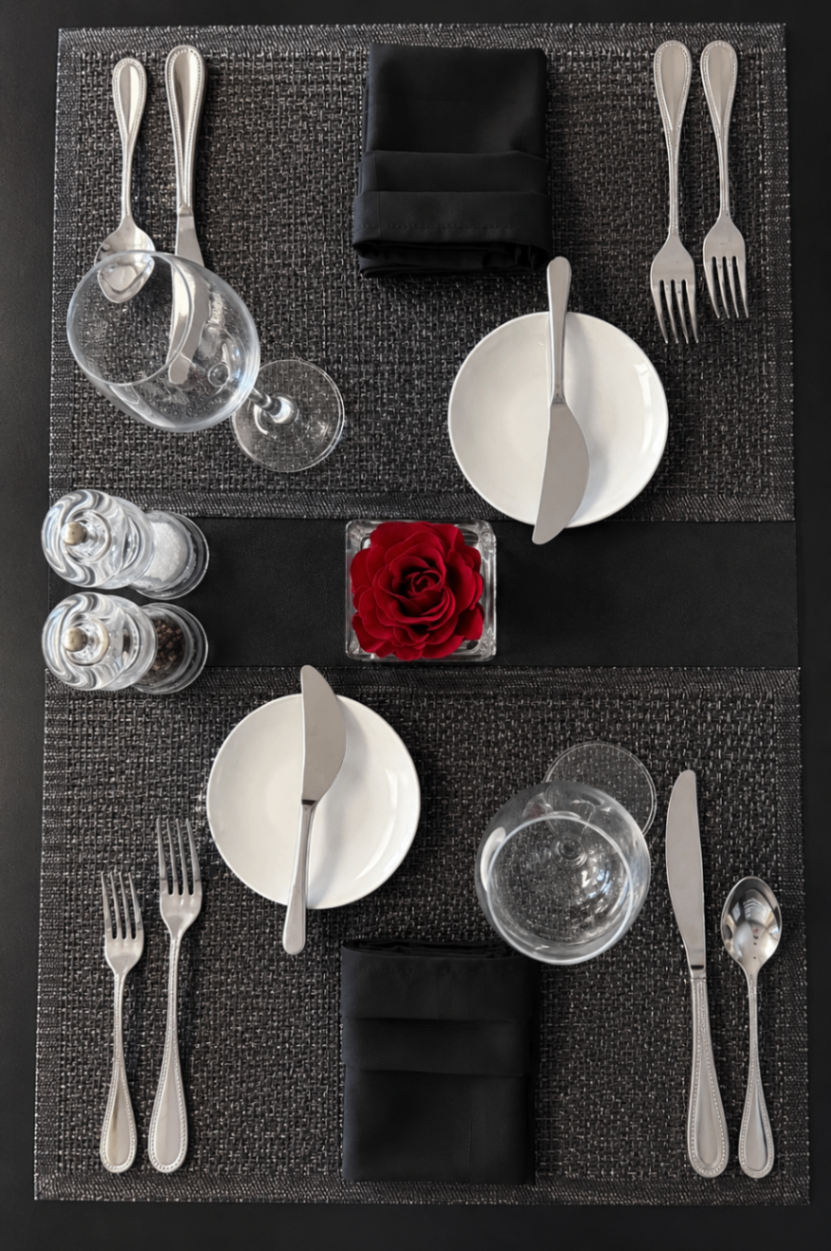 Elegant black-linen table setting with rose centerpiece
