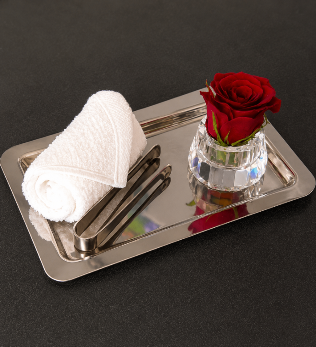 Warm towel service with rose on silver tray