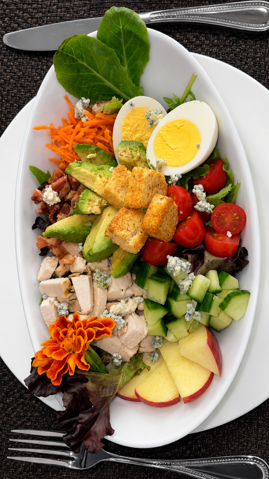 Composed cobb salad with edible flowers